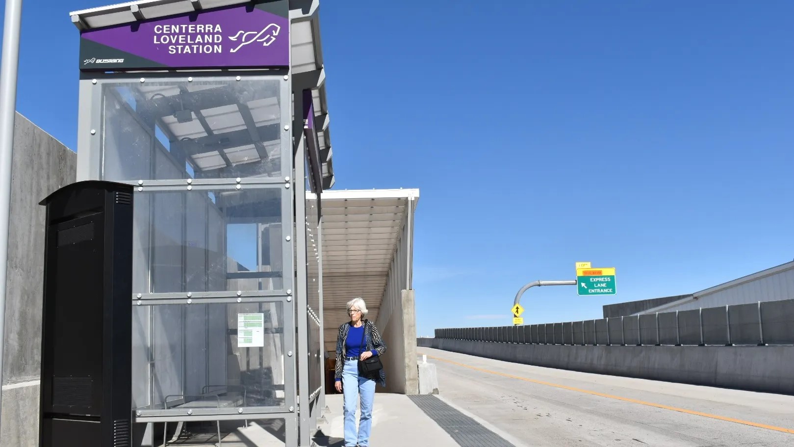 A woman waiting at the Centerra Bustang stop